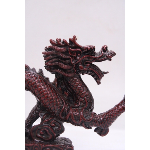 267 - A RED RESIN ORIENTAL DRAGON, HEIGHT 12CM, LENGTH 23CM