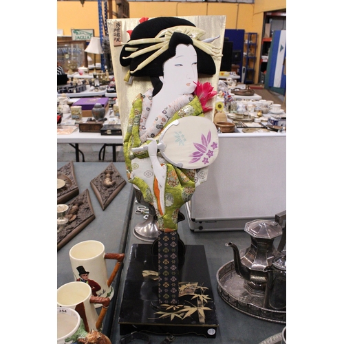 352 - A VINTAGE JAPANESE HAGOITA GEISHA DOLL WITH A SILK PADDLE ON A WOODEN STAND, HEIGHT 75CM