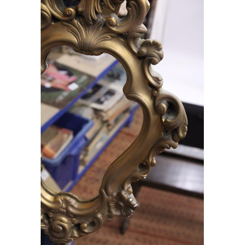 376 - AN ORNATE GILT FRAMED MIRROR