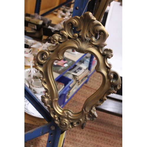 376 - AN ORNATE GILT FRAMED MIRROR