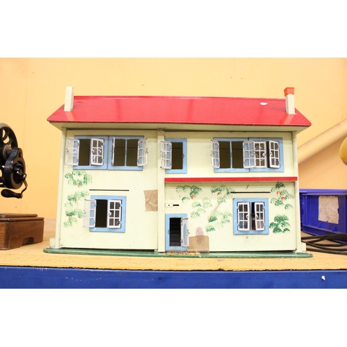 379 - A VINTAGE DOLLS HOUSE CONTAINING A LARGE QUANTITY OF FURNITURE