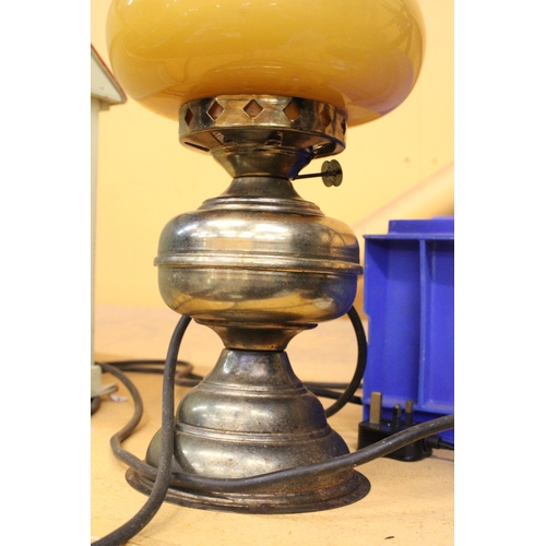 380 - A VINTAGE OIL LAMP WITH MUSTARD COLOURED GLASS SHADE