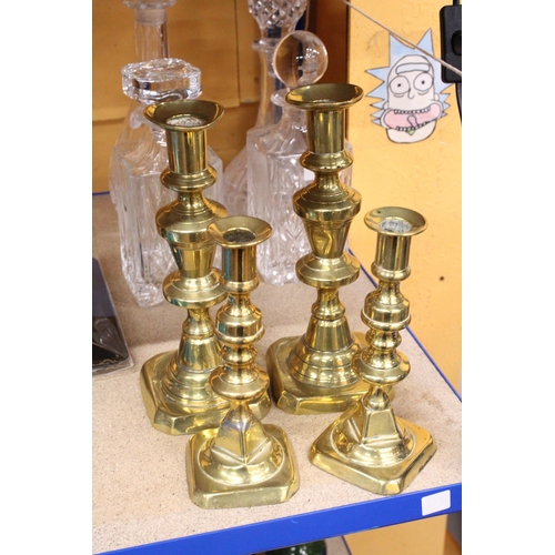 402 - TWO PAIRS OF BRASS CANDLESTICKS