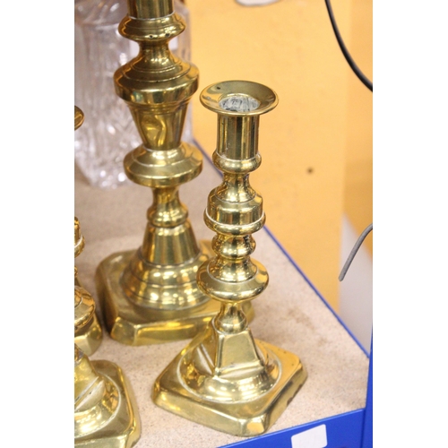 402 - TWO PAIRS OF BRASS CANDLESTICKS