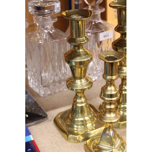 402 - TWO PAIRS OF BRASS CANDLESTICKS