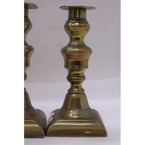 499 - A PAIR OF GEORGIAN BRASS CANDLESTICKS