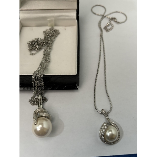 552 - TWO NECKLACES WITH PEARL AND CLEAR STONE PENDANTS AND A PAIR OF MATCHING EARRINGS SOME CIRO IN A PRE... 