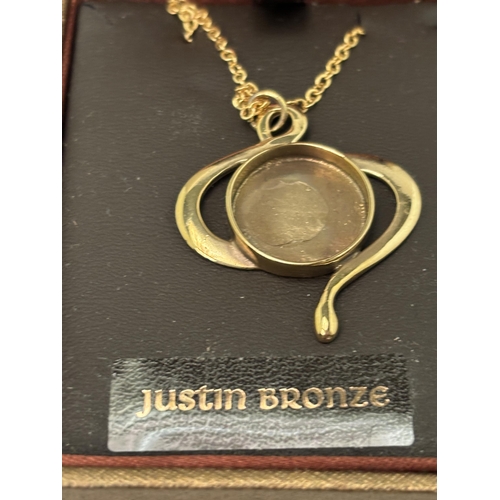 555 - A ST JUSTIN BRONZE NECKLACE IN A PRESENTATION BOX