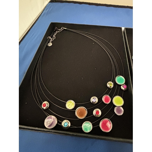 557 - TWO BOXED COLOURED GLASS DESIGNER NECKLACES