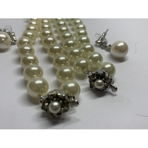 589 - TWO STRINGS OF LARGE PEARLS AND A PAIR OF MATCHING PEARL AND CLEAR STONE DROP EARRINGS