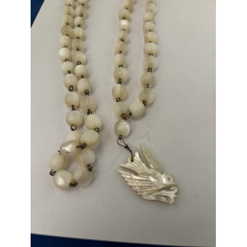 596 - TWO PEARL NECKLACES TO INCLUDE ONE WITH A BIRD PENDANT THE OTHER WITH A MARKED SILVER CLASP