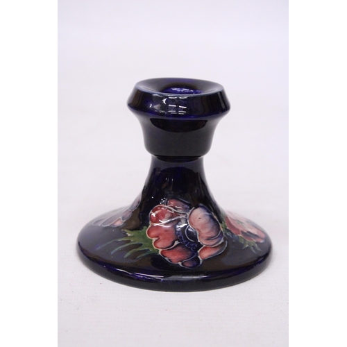 712 - A MOORCROFT CANDLESTICK IN ANEMONE PATTERN