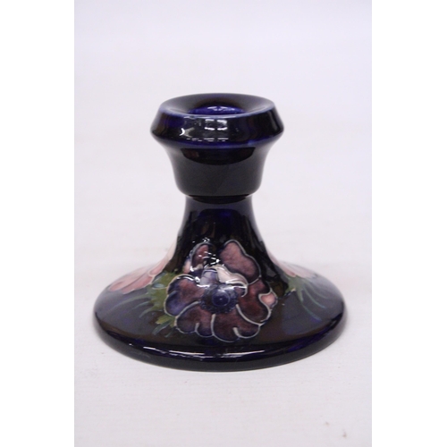 712 - A MOORCROFT CANDLESTICK IN ANEMONE PATTERN