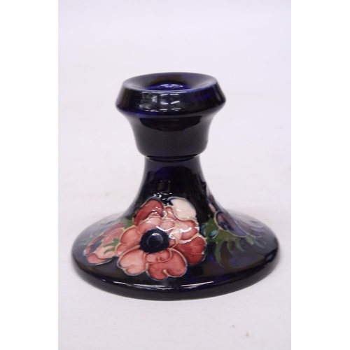 712 - A MOORCROFT CANDLESTICK IN ANEMONE PATTERN