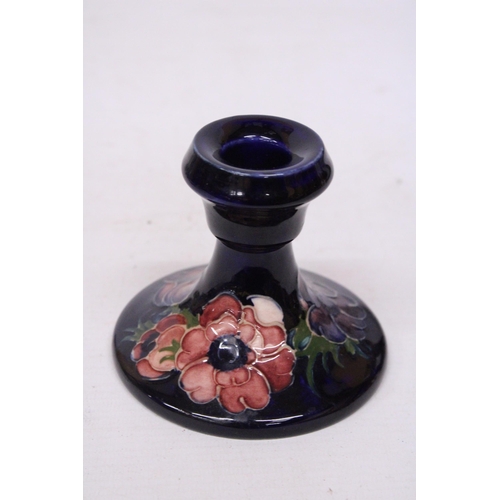 712 - A MOORCROFT CANDLESTICK IN ANEMONE PATTERN