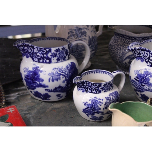 844 - FIVE PIECES OF BLUE AND WHITE POTTERY TO INCLUDE FOUR JUGS AND A COFFEE POT, PLUS A CARLTON WARE JUG... 