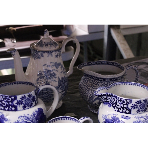 844 - FIVE PIECES OF BLUE AND WHITE POTTERY TO INCLUDE FOUR JUGS AND A COFFEE POT, PLUS A CARLTON WARE JUG... 