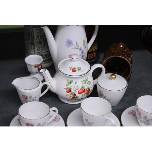 989 - A GERMAN CHINA COFFEE SET TO INCLUDE A COFFEE POT, CREAM JUG, SUGAR BOWL, CUPS AND SAUCERS, PLUS A S... 