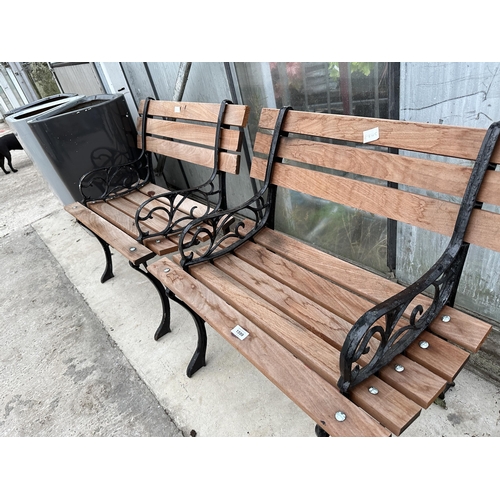 1599 - A PAIR OF WOODEN SLATTED CHAIRS WITH CAST ENDS