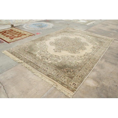 2497 - A LARGE CREAM PATTERNED FRINGED RUG