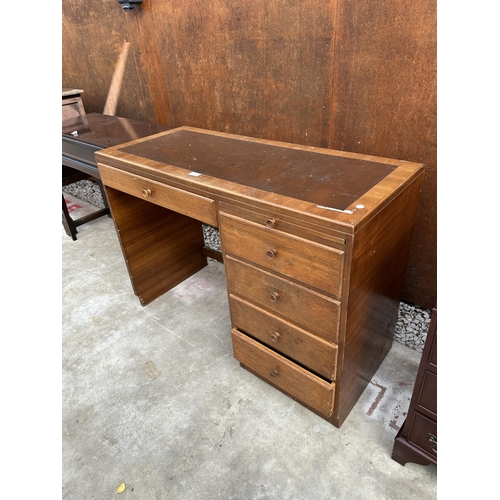 2507 - A RETRO TEAK SINGLE PEDESTAL DESK ENCLOSING FIVE DRAWERS AND SLIDE, 42