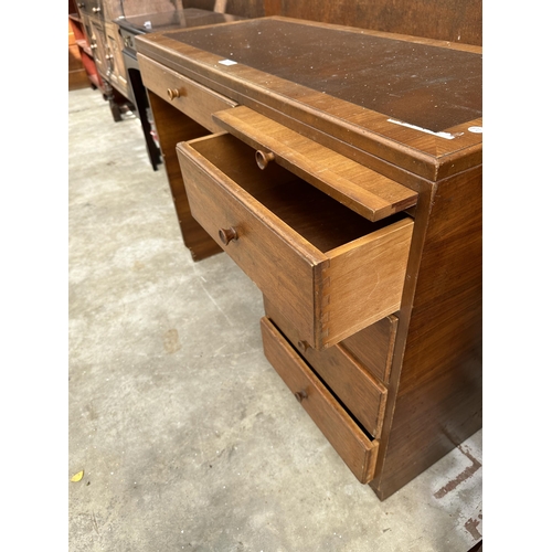 2507 - A RETRO TEAK SINGLE PEDESTAL DESK ENCLOSING FIVE DRAWERS AND SLIDE, 42