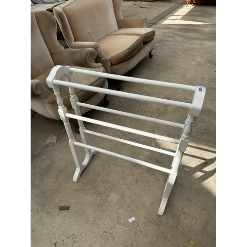 2534 - A PAINTED SIX BAR TOWEL RAIL AND A SPANISH STYLE MAGAZINE RACK