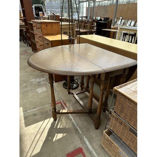 2562 - AN OAK AND BEECH GATE-LEG TABLE ON TURNED LEGS, 50