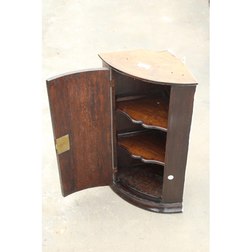 2672 - A SMALL OAK BOW FRONTED CORNER CUPBOARD WITH SHAPED INTERIOR SHELVES, 14