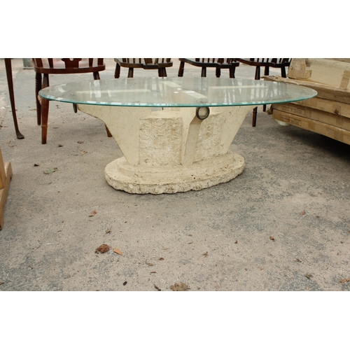 2727 - AN OVAL GLASS COFFEE TABLE ON A STONE EFFECT BASE 51