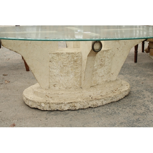 2727 - AN OVAL GLASS COFFEE TABLE ON A STONE EFFECT BASE 51