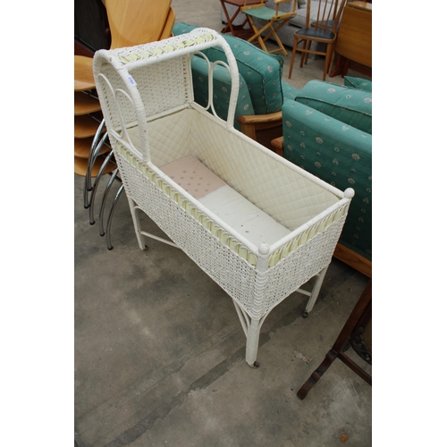 2763 - A PAINTED WICKER CRIB ON CASTORS