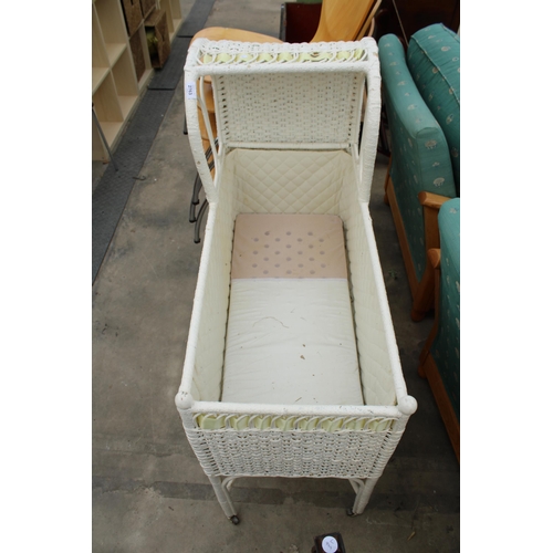 2763 - A PAINTED WICKER CRIB ON CASTORS