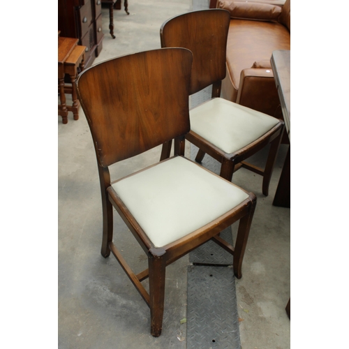 2778 - A WALNUT AND ART DECO DRAW-LEAF DINING TABLE AND FOUR CHAIRS