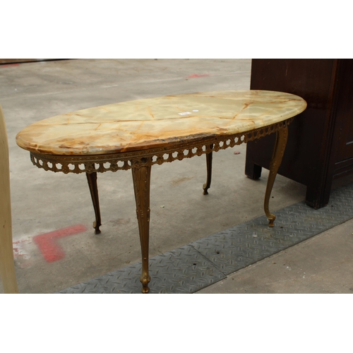 2788 - AN OVAL ONYX COFFEE TABLE ON BRASS LEGS