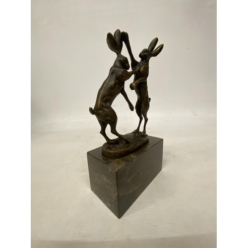 14 - A SIGNED BRONZE FIGURE OF FIGHTING HARES ON A MARBLE BASE