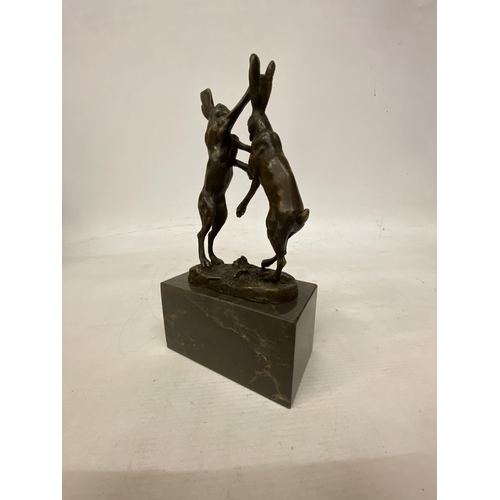 14 - A SIGNED BRONZE FIGURE OF FIGHTING HARES ON A MARBLE BASE