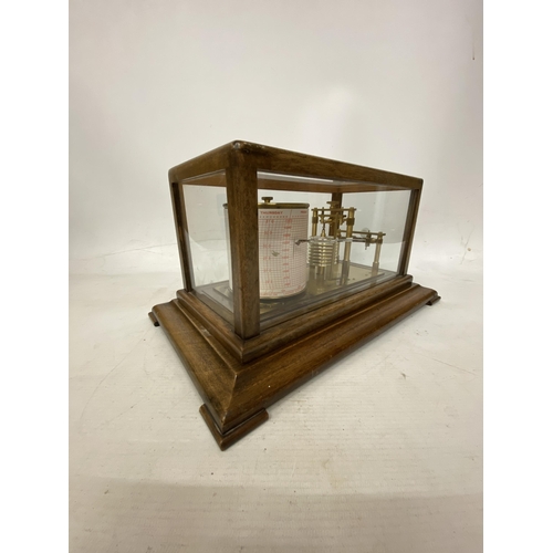 35 - A VINTAGE OAK CASED BAROGRAPH WITH SPARE CHARTS