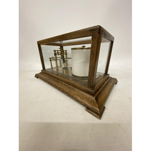 35 - A VINTAGE OAK CASED BAROGRAPH WITH SPARE CHARTS