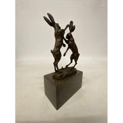 14 - A SIGNED BRONZE FIGURE OF FIGHTING HARES ON A MARBLE BASE