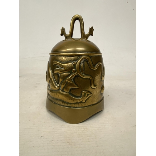 2 - A CHINESE TEMPLE BELL DECORATED WITH DRAGONS SUPPORTED WITHIN A CARVED HARD WOOD STAND