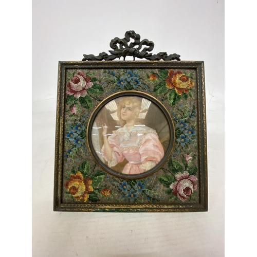 20 - A FRENCH STYLE BEADED MATT FRAME WITH CONVEX GLASS WITH A SILK BACK (POSSIBLY MID VICTORIAN) DEPICTI... 