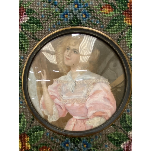 20 - A FRENCH STYLE BEADED MATT FRAME WITH CONVEX GLASS WITH A SILK BACK (POSSIBLY MID VICTORIAN) DEPICTI... 