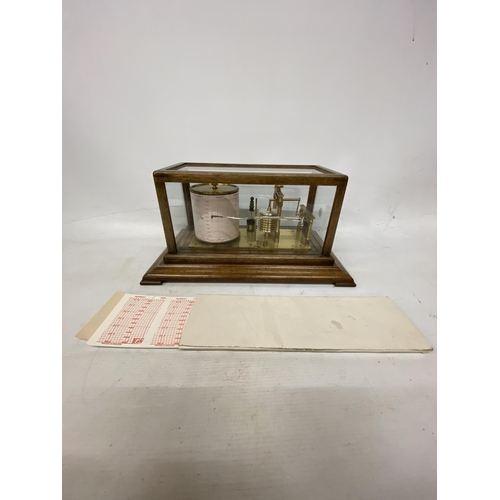 35 - A VINTAGE OAK CASED BAROGRAPH WITH SPARE CHARTS