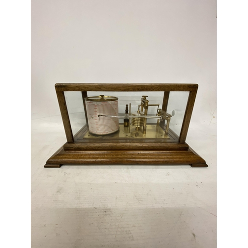 35 - A VINTAGE OAK CASED BAROGRAPH WITH SPARE CHARTS