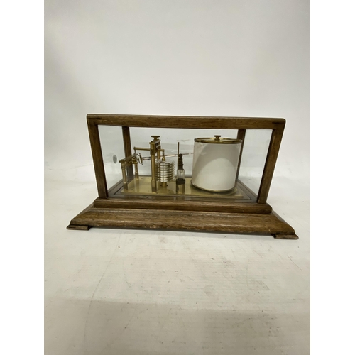 35 - A VINTAGE OAK CASED BAROGRAPH WITH SPARE CHARTS