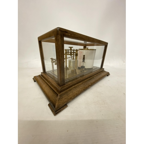 35 - A VINTAGE OAK CASED BAROGRAPH WITH SPARE CHARTS