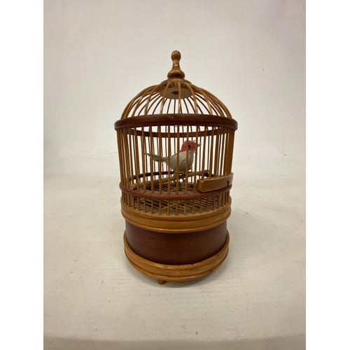 4 - A VINTAGE BAMBOO BIRD CAGE WITH SINGING GOLDFINCH IN WORKING ORDER BUT NO WARRANTY GIVEN