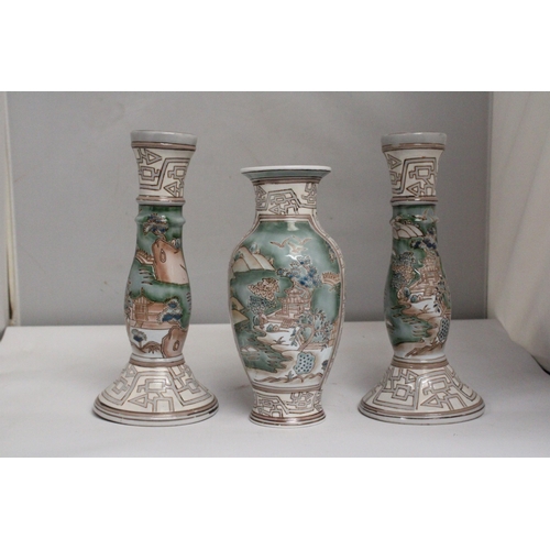  A VINTAGE CHINESE ENAMELLED PORCELAIN VASE TOGETHER WITH A PAIR OF MATCHING CANDLESTICKS BOTH WITH R... 