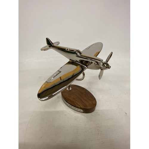 21 - A CHROME SPITFIRE ON A WOODEN BASE